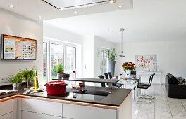 White open kitchen with eating bar and dining area