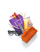 Handbag, sunglasses, book, make-up, cosmetics and pouch on white background, overhead view
