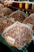 Baskets of snacks covered with net in Souk El Tayeb organic market, Beirut, Lebanon