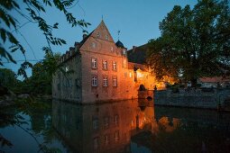 View of Hulsede Water Castle at night, Lower Saxony, Germany