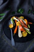 Oven-roasted vegetables with orange and thyme on a plate