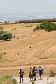 Pilgrims walking on road to Jesus Trail near Mount Arbel, Capernaum, Galilee, Israel