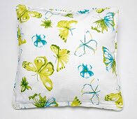 Cushion cover with butterfly motifs on white background