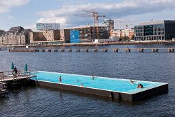 People enjoying at bathing ship pool on Spree river at Wrangelkiez, Berlin, Germany