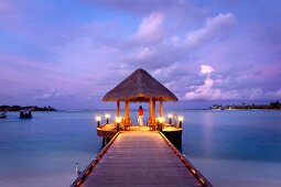 View of gazebo on jetty at sunset in Dhigufinolhu island, Maldives