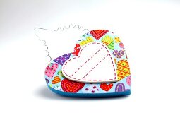 Colourful heart with heart motif on white background