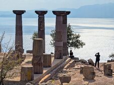 Tourists photographing at Temple of Athena near sea in Turkey