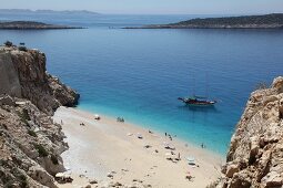 People and two ships at Kaputas beach in Turkey