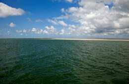 View of horizon on water and clouds at Fano Beach, Denmark