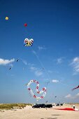 Multi-coloured flags in sky on kite festival at Fano beach, Denmark