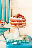 A layered sponge cake with cream and strawberries