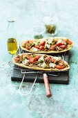Unleavened bread pizzas with date tomatoes and goat's cheese