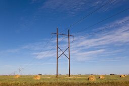 Landscape view of power pole and straw bales on Highway 15,  Saskatchewan, Canada