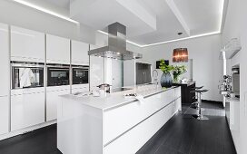 View of open kitchen with narrow kitchen island in black and white