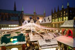 Lubeck Christmas market decorated with lights in front of Town Hall, Germany