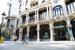 View of tourists on road near Hotel Casa Fuster at Barcelona, Spain