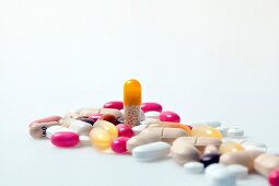 Close-up of different pills, tablets, dragees and capsules on white background