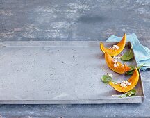 Roasted pumpkin wedges on a baking tray