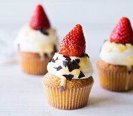 Egg nog cupcakes with strawberries and cream