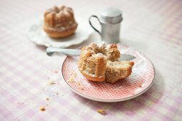 A mini nut Bundt cake on a plate with a knife, sliced