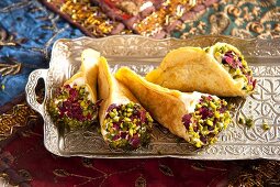 Quataif with pistachios (filled crepes, Arabia)