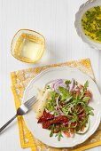 Rocket salad with dried tomatoes and cheese