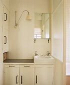 Simple, white bathroom with wash basin and vanity