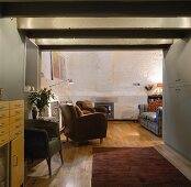 Cozy sofa corner with armchairs in front of a chimney in an old home