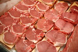 Pork Chops and Butterflied Pork Chops in a Display Case at a Market