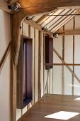 Lobby of a renovated timbered house with modern windows