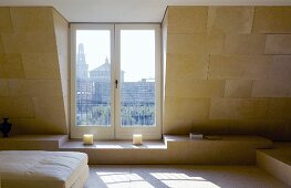 Modern living room under a roof with terrace door and view of the city