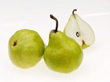 An arrangement of pears, one halved