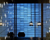 Lobby with hanging lamps in front of a blue, shimmering wall