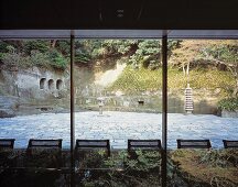 View through a glass facade of a traditional, Japanese courtyard
