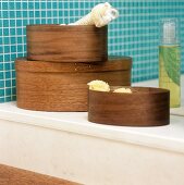 Wooden boxes on a shelf in a bathroom