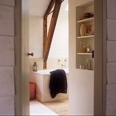 A view into a bathroom with wooden beams