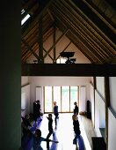 A yoga class in a renovated attic with wooden beams