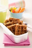 Spicy waffles and vegetable crudités in a lunchbox