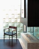 50s armchair in front of white structured wall