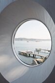 View of jetties on a lake through circular window