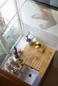 Looking down onto tiny kitchen unit with kitchen implements in window niche