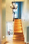 Recessed spotlights on wooden stairs in traditional stairwell
