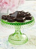 Chocolate Coated Heart Cakes on a Green Glass Pedestal Dish
