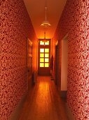 Narrow hall with ornate red and white patterned wallpaper