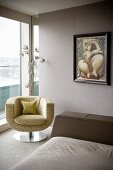 Upholstered swivel chair in front of standard lamp by window