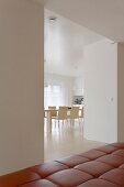 View of modern dining area through wide doorway