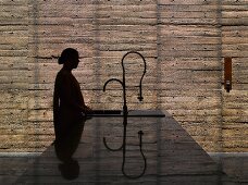 Woman standing at kitchen island sink