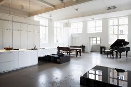 Living space with open kitchen, dining table & piano