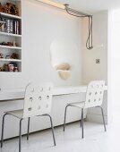 Chairs in front of built-in table top, niche and shelves