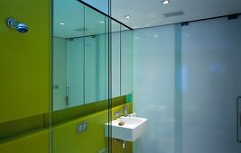 Bathroom with sink, mirror, yellow glass wall & opaque glass wall